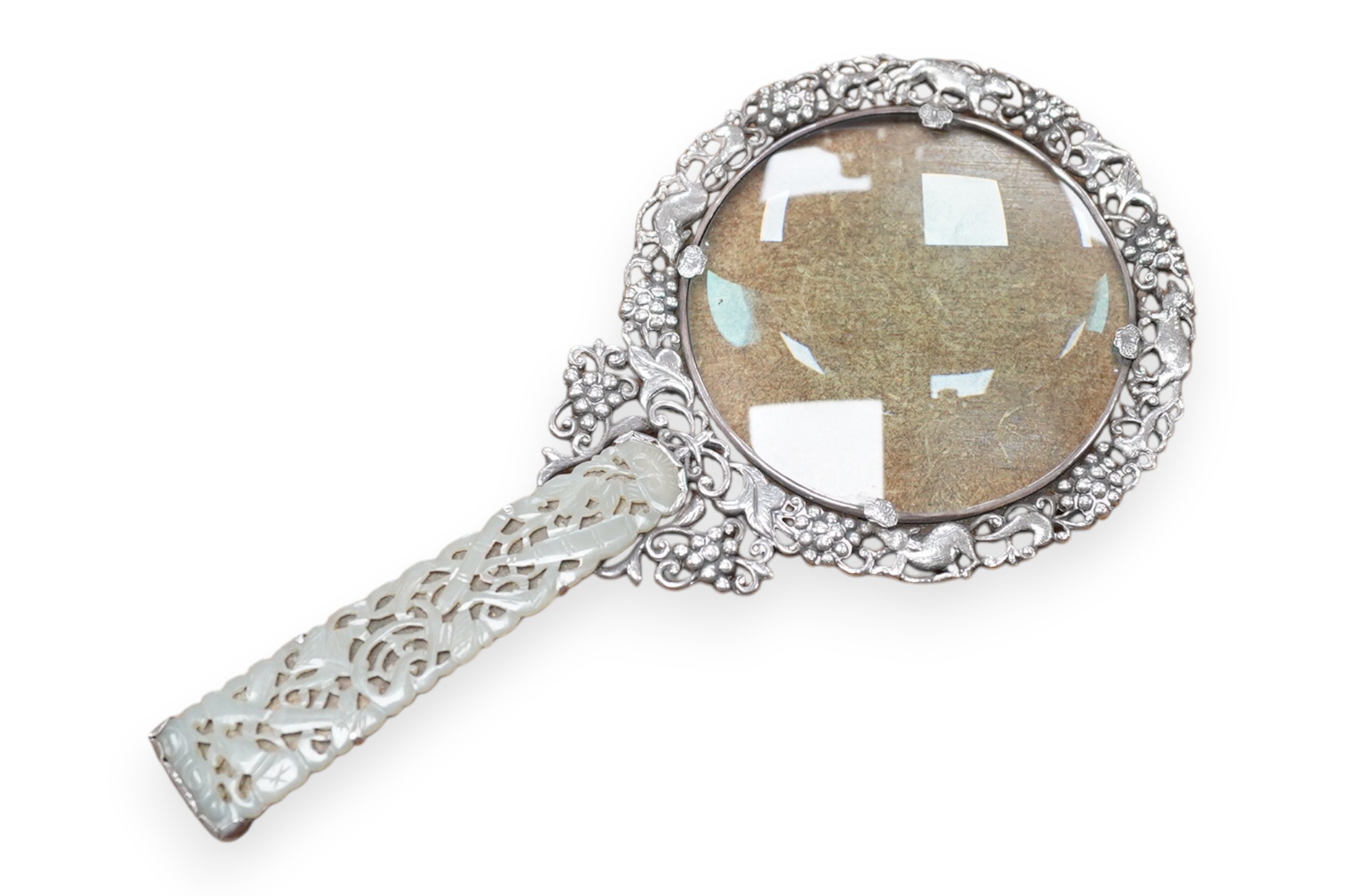 A Chinese white metal and pale celadon jade handled magnifying glass, early 20th century, stamped ‘SILVER’, 19cm long. Condition - good